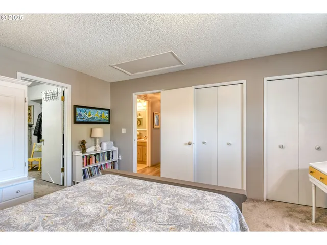 a view of a bedroom with wooden floor and furniture