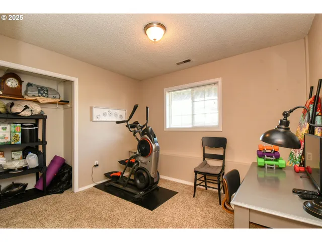 a room with furniture a flat screen tv and a window