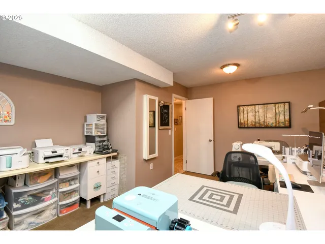 a living room with a bed furniture and kitchen view