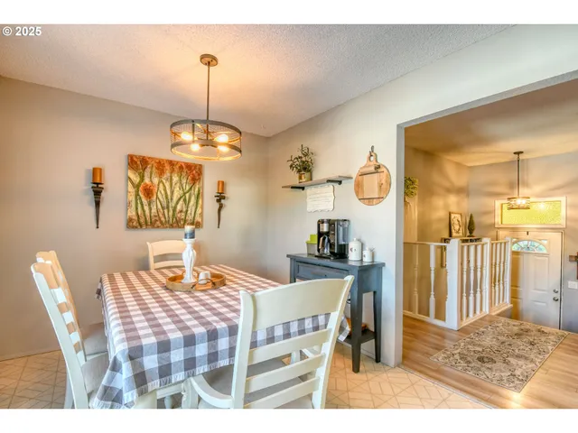 a dining room with a wooden table and chairs