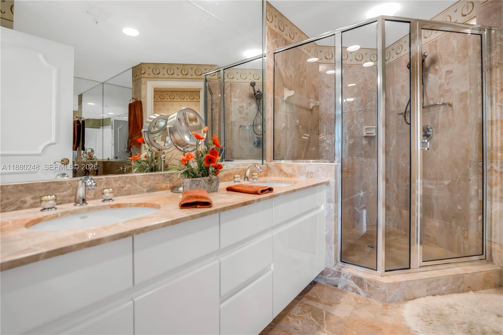 888 Brickell Key Drive, Unit 1807 Miami, FL 33131 - Photo 20 of 58 a bathroom with a double vanity sink mirror and shower