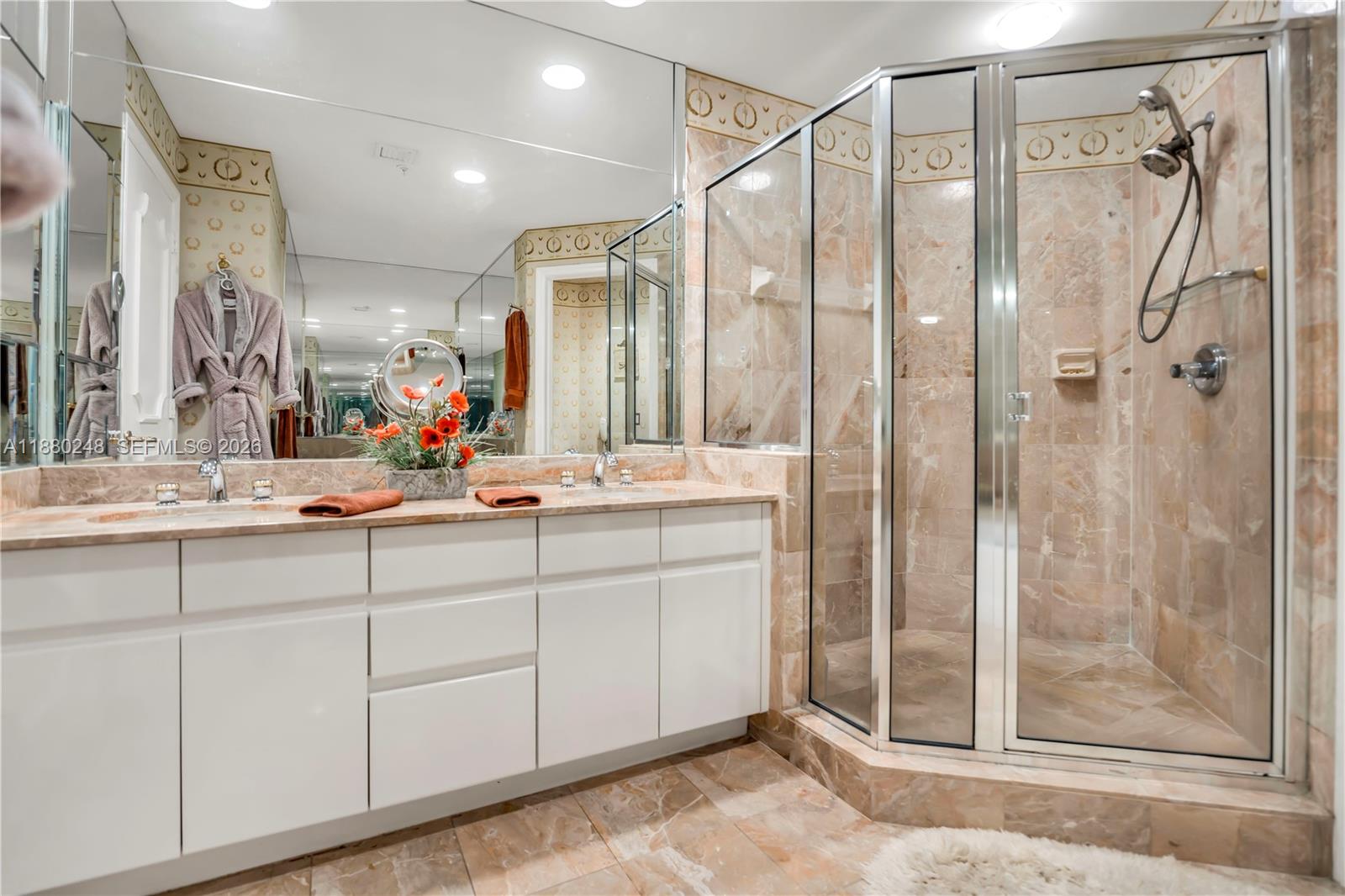 888 Brickell Key Drive, Unit 1807 Miami, FL 33131 - Photo 21 of 58 a bathroom with a double vanity sink mirror and shower