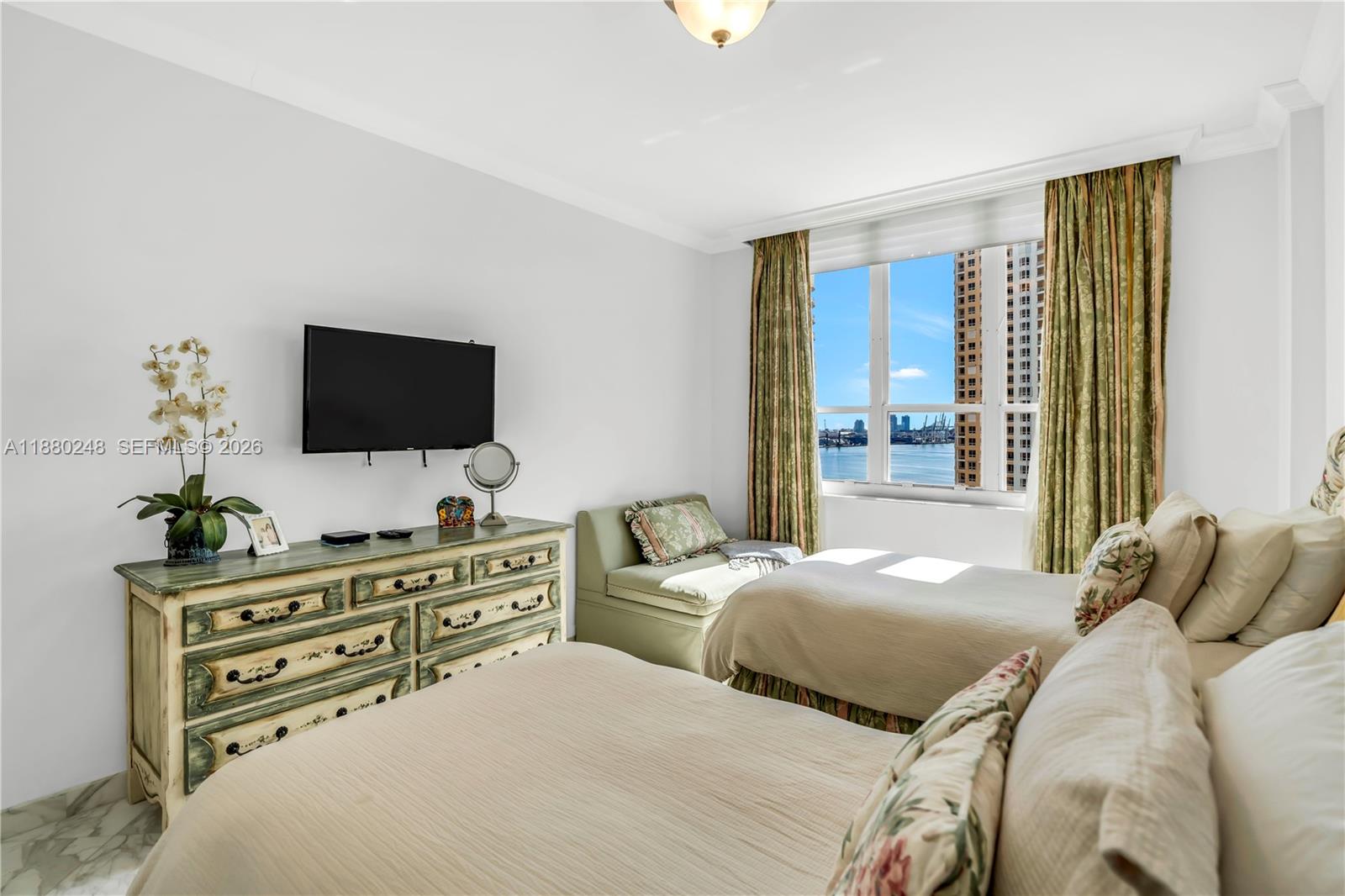 888 Brickell Key Drive, Unit 1807 Miami, FL 33131 - Photo 28 of 58 a bedroom with two bed and a flat screen tv