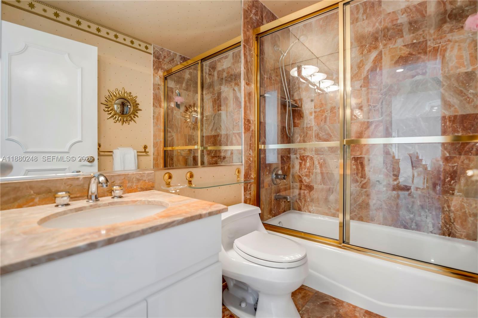 888 Brickell Key Drive, Unit 1807 Miami, FL 33131 - Photo 29 of 58 a bathroom with a sink and a mirror