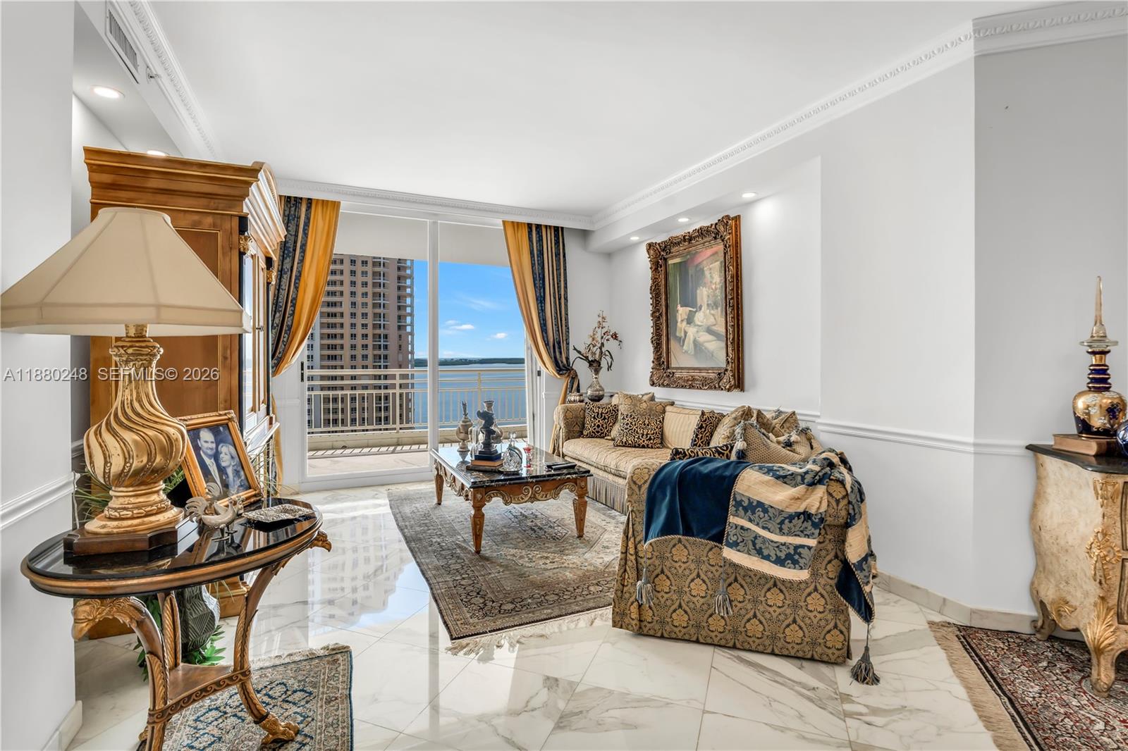 888 Brickell Key Drive, Unit 1807 Miami, FL 33131 - Photo 4 of 58 a living room with furniture a rug and a window