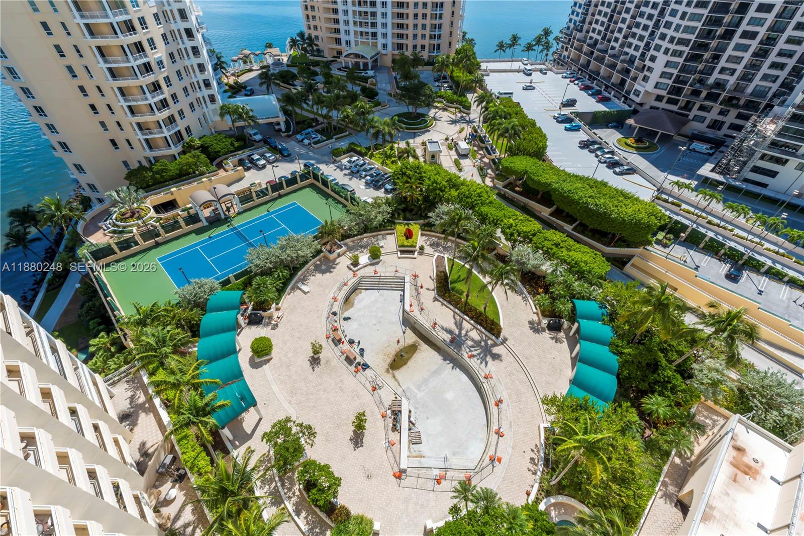 888 Brickell Key Drive, Unit 1807 Miami, FL 33131 - Photo 41 of 58 a view of a swimming pool with a yard and plants