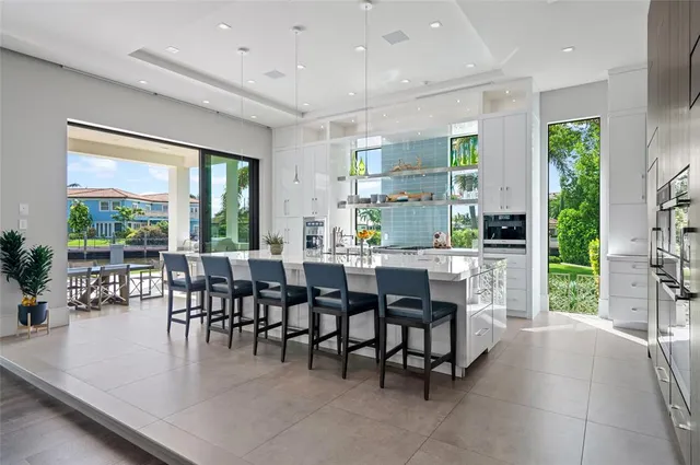 a dining hall with stainless steel appliances a dining table and chairs