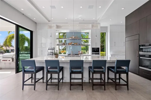 a dining room with furniture a rug and a floor to ceiling window