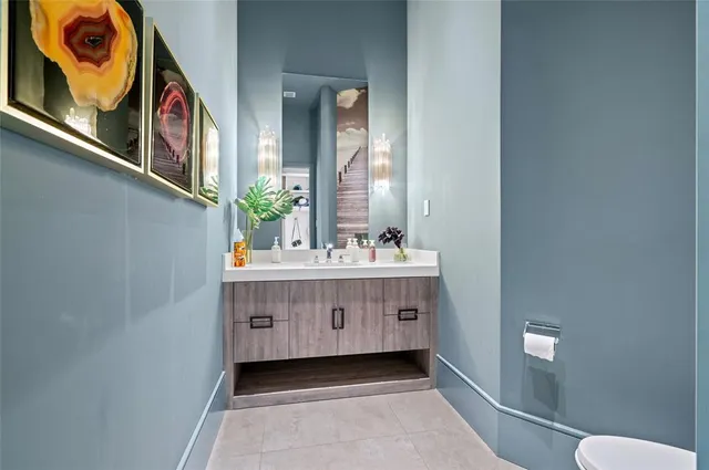 a bathroom with a sink a mirror and a toilet