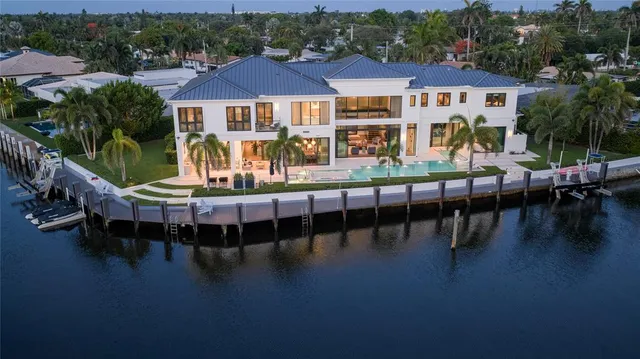 a view of a house with pool and chairs