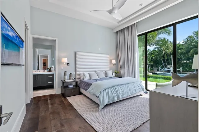 a living room with a large bed and a view of balcony