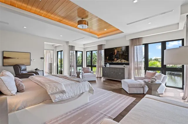 a bedroom with furniture and a flat screen tv