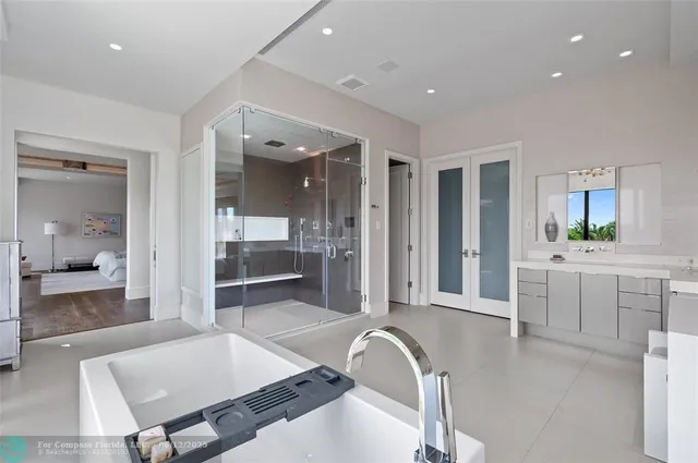 a bathroom with a tub a potted plant and a sink