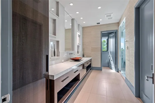 a bathroom with a tub a potted plant and a sink