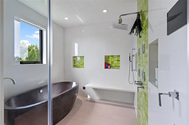 a bedroom with furniture and a large window