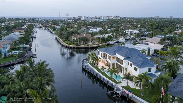 an aerial view of a house with garden space and lake view