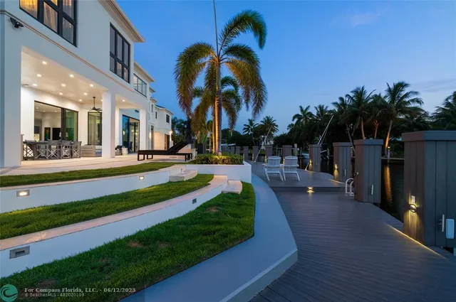 a roof deck with table and chairs a barbeque with potted plants