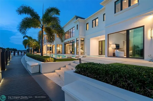 a view of a patio with a table and chairs under an umbrella