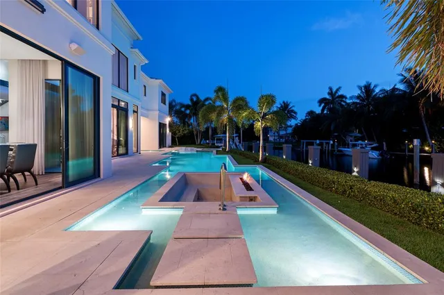 a view of a patio with a table and chairs under an umbrella