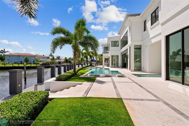 a view of house with swimming pool and outdoor seating