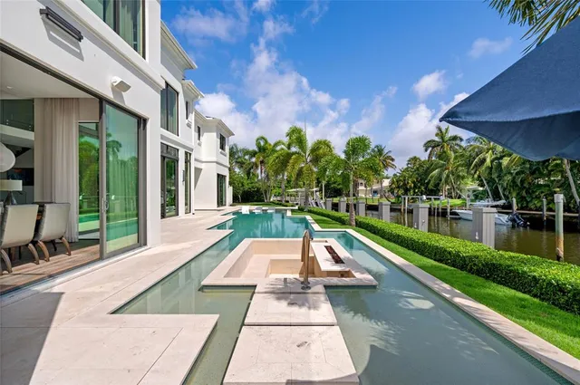 a view of house with swimming pool and outdoor seating