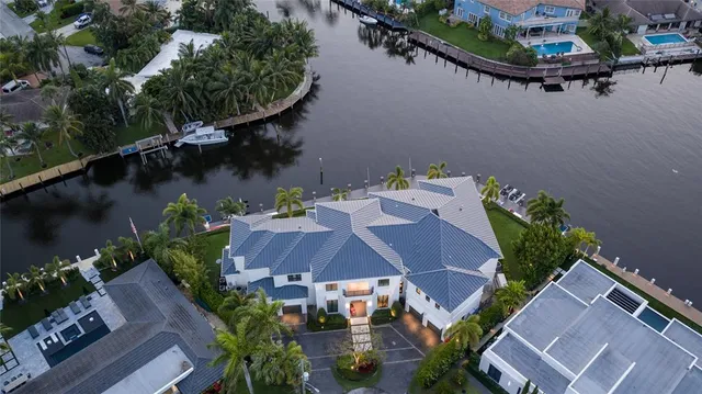 an aerial view of a house with garden space and lake view