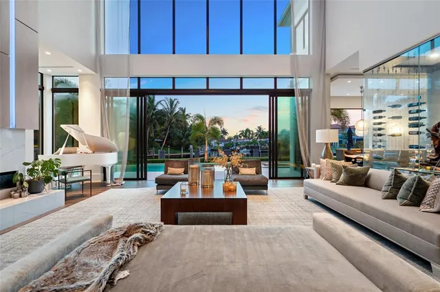 a living room with patio furniture and a large window