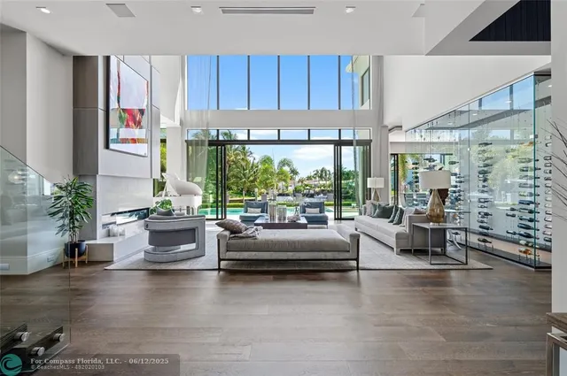 a living room with patio furniture and a large window
