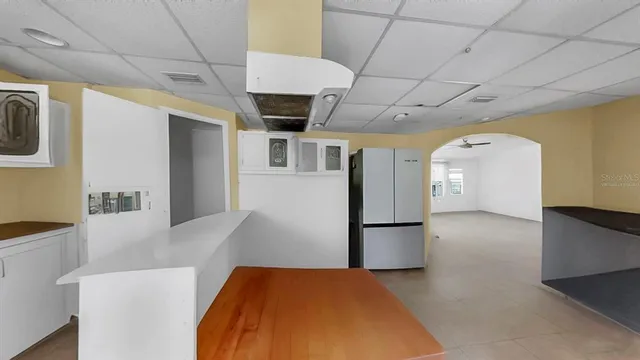 a view of a kitchen with a refrigerator and a stove top oven