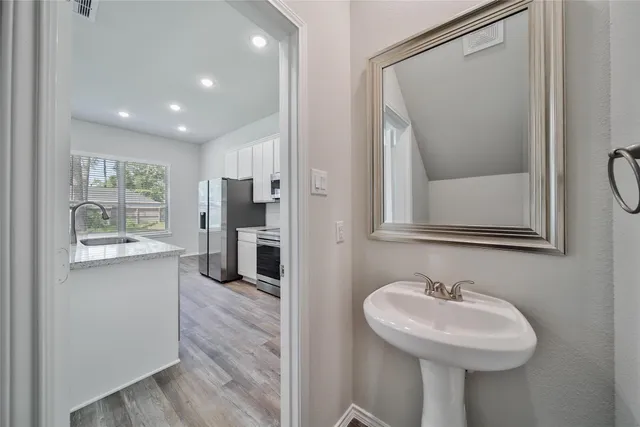 a bathroom with a sink a mirror and a shower