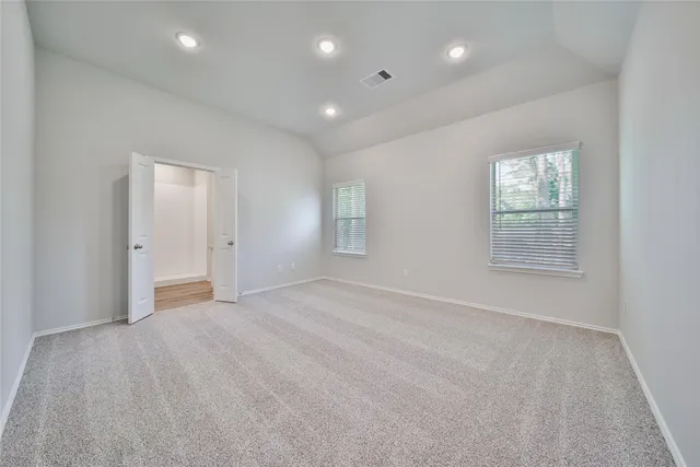 an empty room with windows and closet