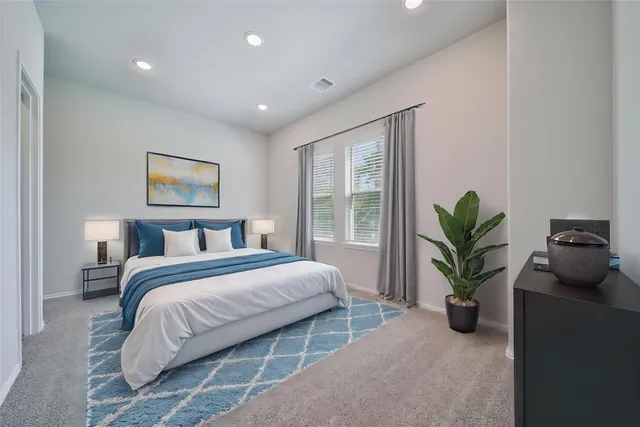 a bedroom with a bed and a potted plant