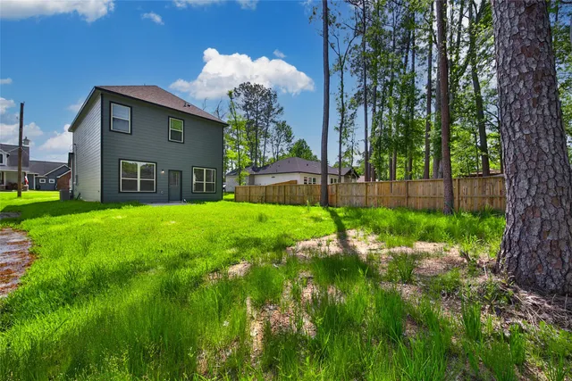 a view of a house with a backyard