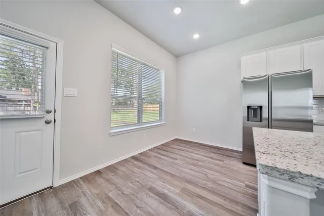 a view of a kitchen cabinets and wooden floor