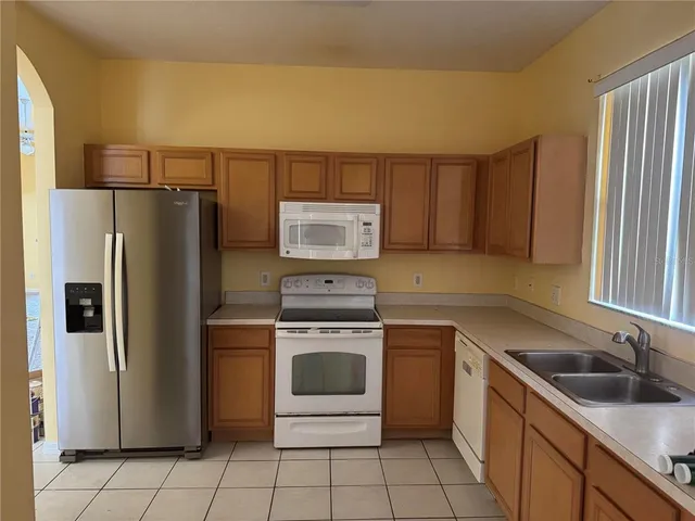 a kitchen with a stove sink and refrigerator