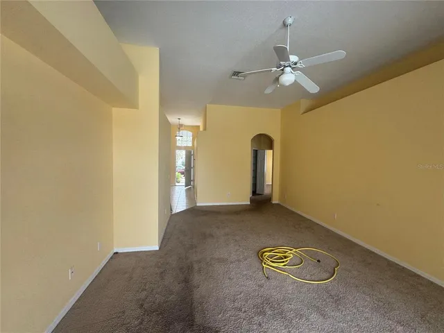 a view of a livingroom with a chandelier fan and furniture