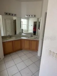 a large kitchen with a sink and cabinets