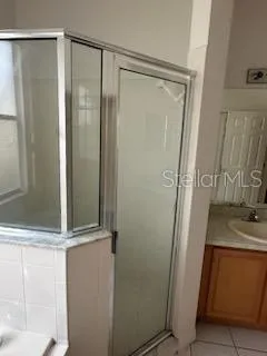 a bathroom with a shower and a sink