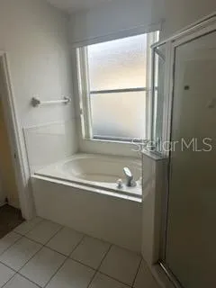a bathroom with a bathtub and a shower