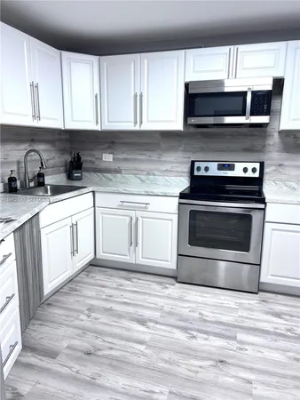 a kitchen with a stove and a microwave