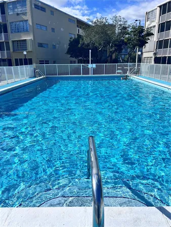 a view of yard with swimming pool and seating