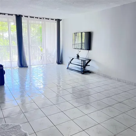 a view of a livingroom with furniture and a window