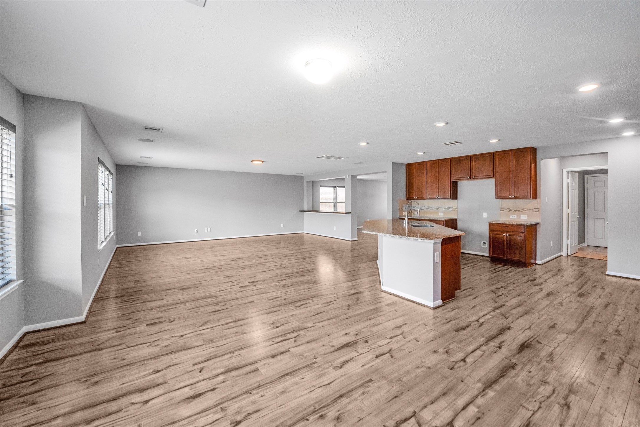 1107 Epworth Ct. Conroe, TX 77304 - Photo 13 of 38 a view of kitchen and hall with wooden floor