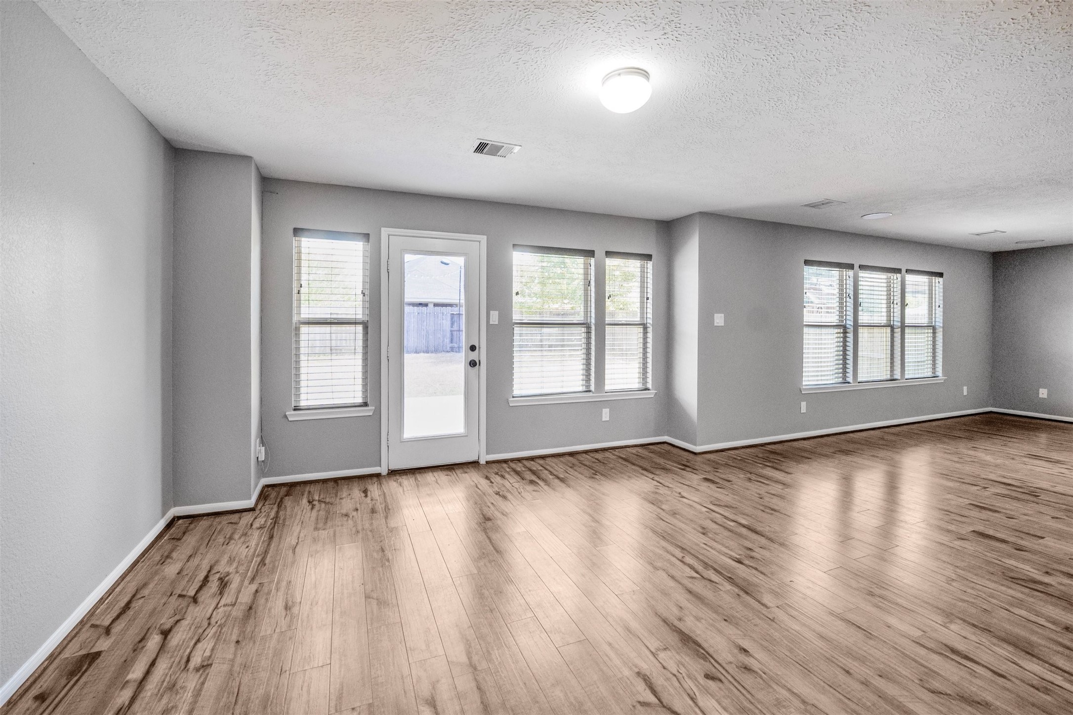 1107 Epworth Ct. Conroe, TX 77304 - Photo 15 of 38 a view of an empty room with wooden floor and window