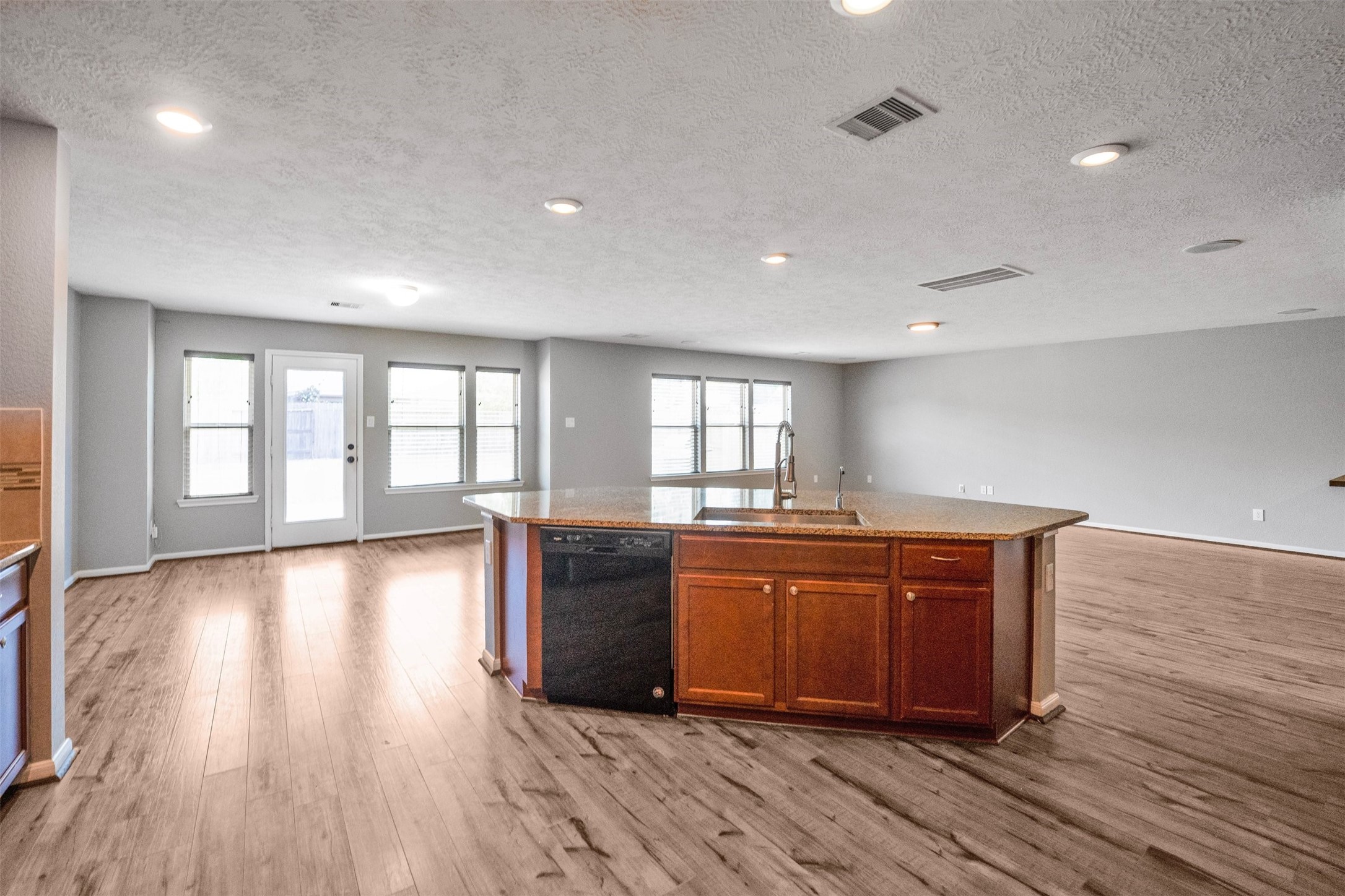 1107 Epworth Ct. Conroe, TX 77304 - Photo 17 of 38 a view of kitchen with granite countertop cabinets and wooden floor