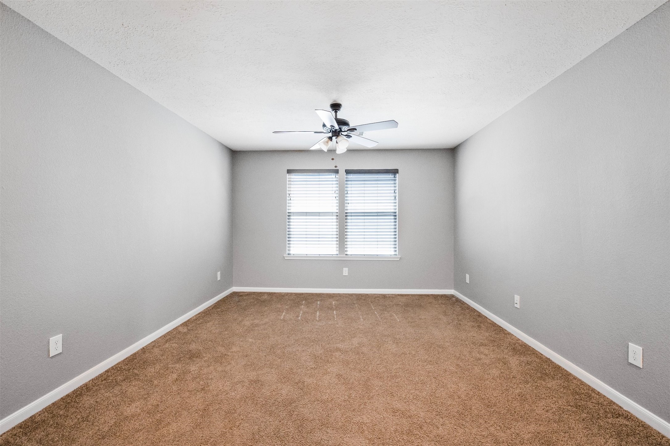 1107 Epworth Ct. Conroe, TX 77304 - Photo 19 of 38 an empty room with a window and a ceiling fan