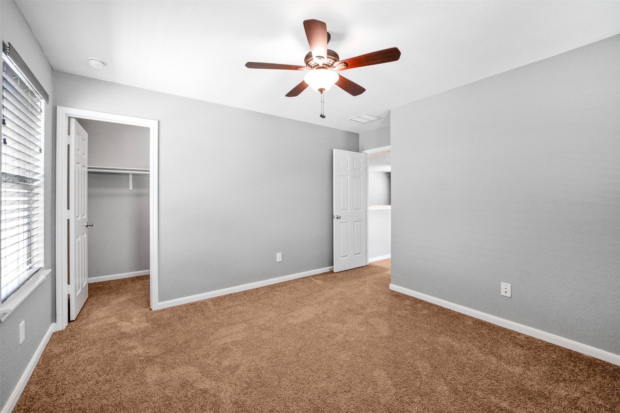 1107 Epworth Ct. Conroe, TX 77304 - Photo 27 of 38 an empty room with ceiling fan and window