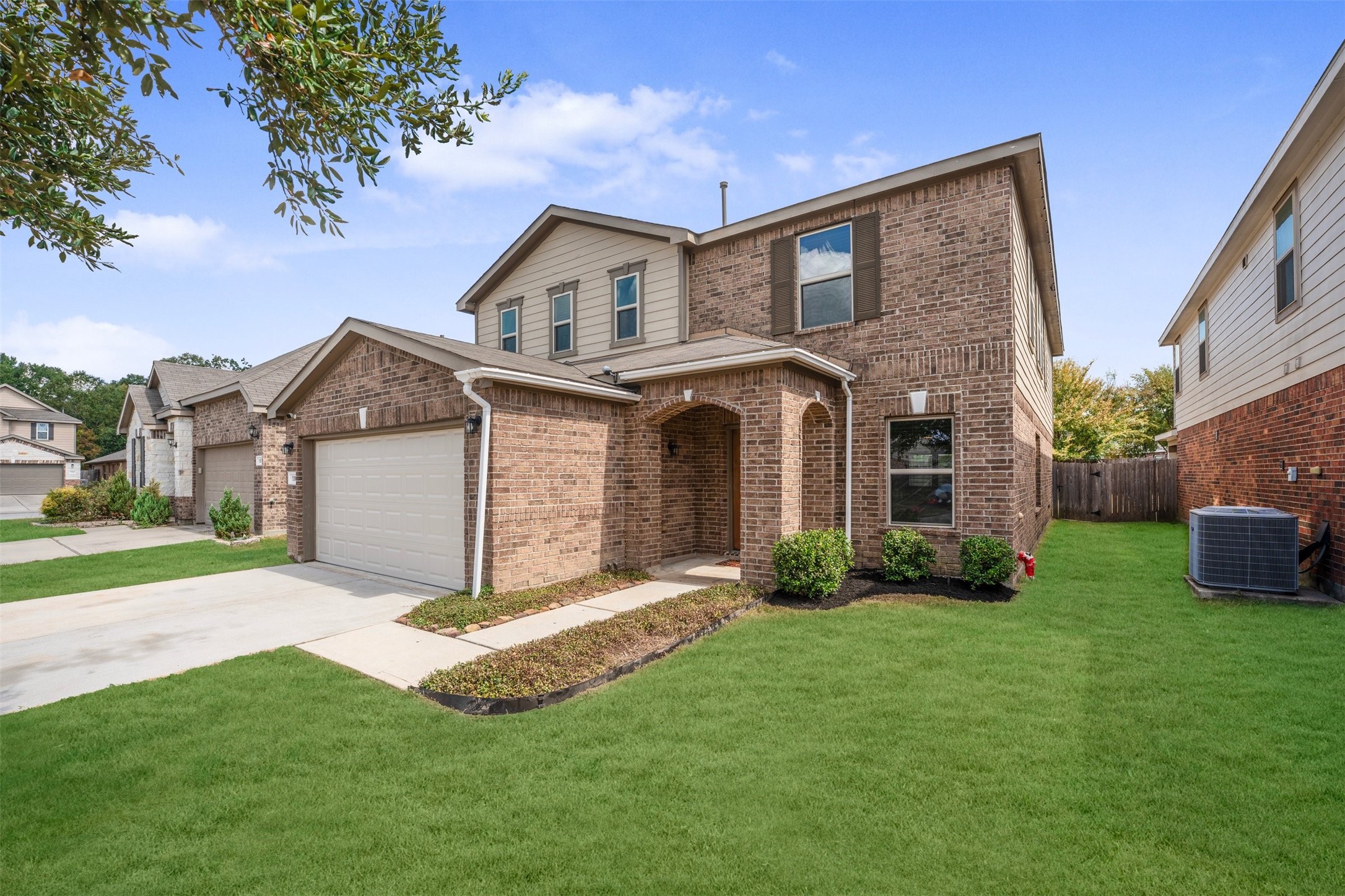 1107 Epworth Ct. Conroe, TX 77304 - Photo 3 of 38 a front view of a house with a yard and garage