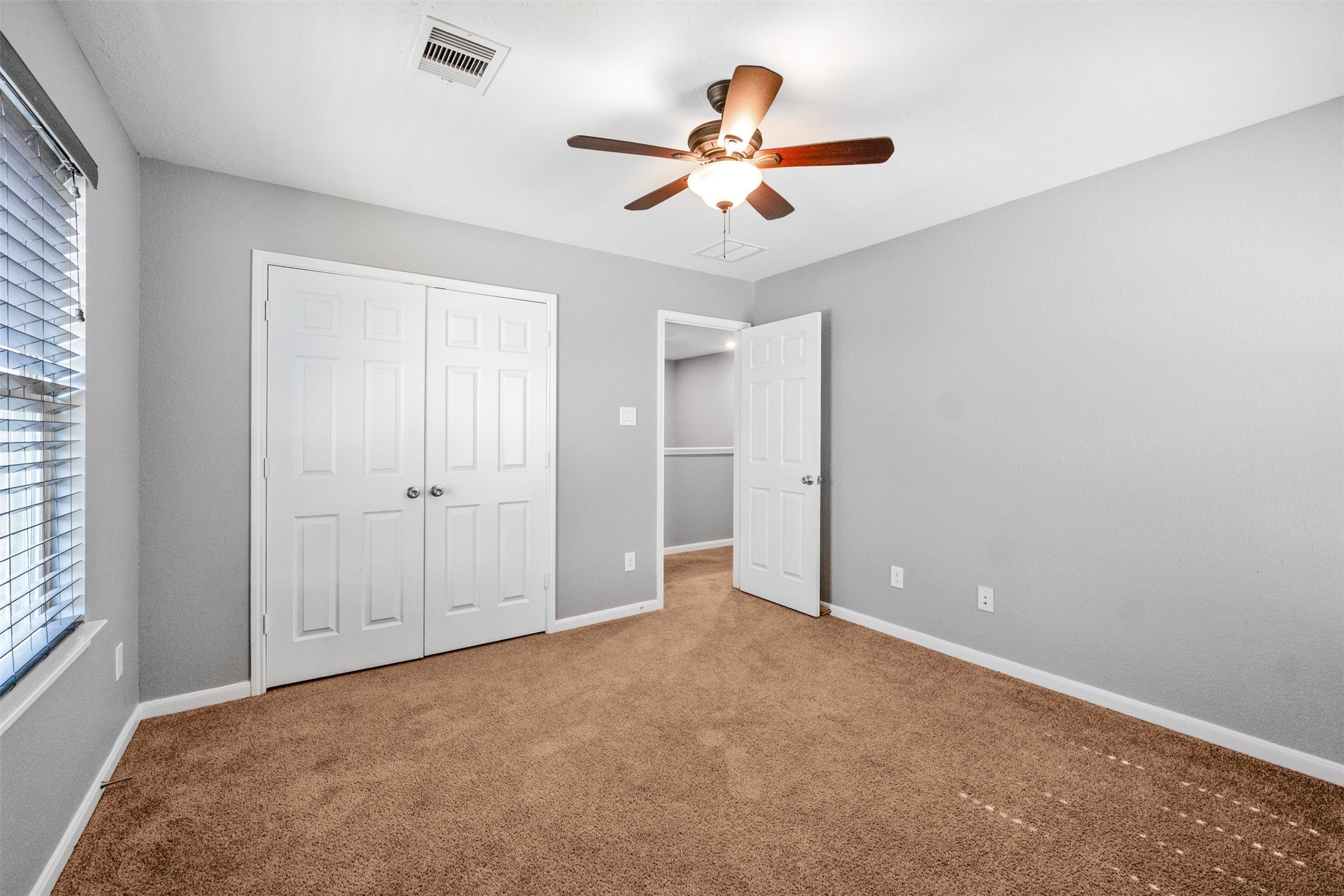 1107 Epworth Ct. Conroe, TX 77304 - Photo 32 of 38 an empty room with a ceiling fan and window
