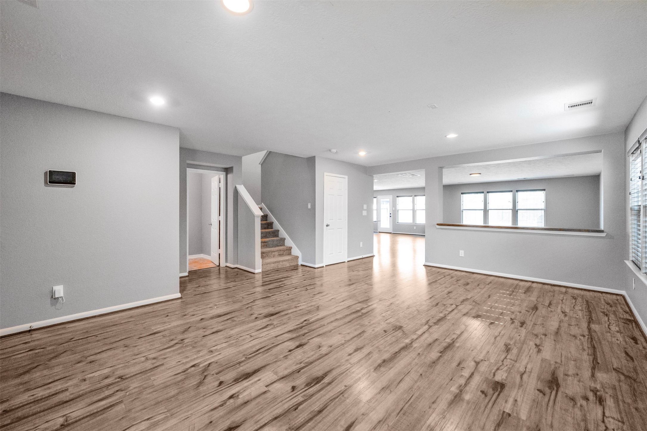 1107 Epworth Ct. Conroe, TX 77304 - Photo 7 of 38 a view of an empty room with wooden floor and a window